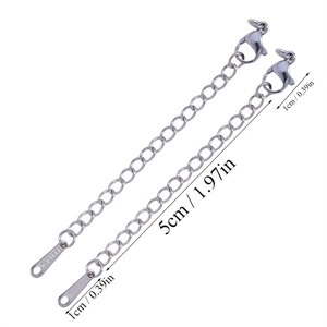 Macro view of 5cm stainless steel extender chains with lobster clasp and S.STEEL tag