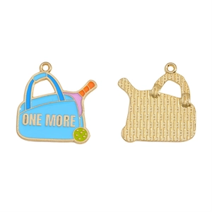 Detailed view of enamel pickleball charm with blue bag and golden grid texture back