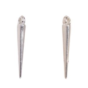 Close-up of polished silver cone pendants with rings for DIY punk jewelry making