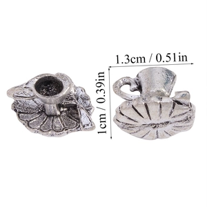 Macro view of vintage silver teapot pendant with 1.3cm scale and floral base detail
