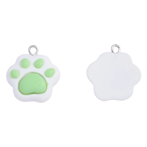 Detail of white resin paw charm with green pads and silver metal ring attachment