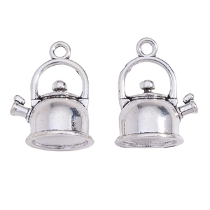 Detailed close-up of antique silver teapot charms for jewelry making DIY craft