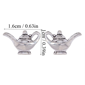 Detailed view of silver magic lamp charms with vintage finish and dimension markings