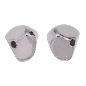 Macro detail of irregular silver CCB spacer beads with smooth mirror finish for DIY jewelry