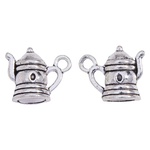 Macro detail of pair of vintage silver alloy teapot charms for jewelry DIY crafts