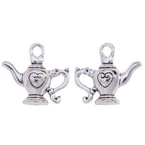 Detailed view of vintage silver teapot charms with embossed heart patterns for DIY jewelry