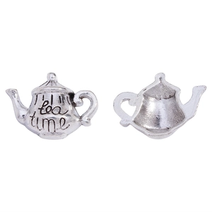 Detailed macro view showing the front and back of the teapot pendant with tea time engraving