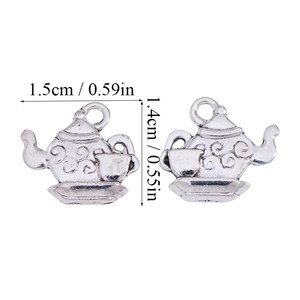 Macro detail of alloy teapot charms with precise dimensions in centimeters and inches