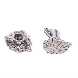 Close-up of vintage silver alloy miniature coffee cup charms with antique matte texture