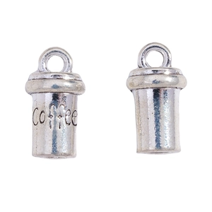 Macro detail of antique silver coffee cup charms with embossed text for DIY jewelry
