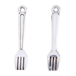Detail of antique silver alloy fork pendants for DIY jewelry making on white background