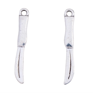 Macro detail of silver alloy scalpel charms with vintage texture and circular hanging rings