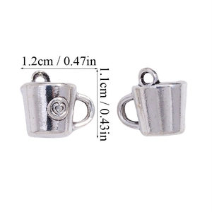 Detailed view of silver coffee cup pendants with heart logo and size measurements