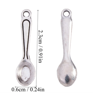 Macro view of miniature silver alloy spoon pendant for DIY jewelry with size dimension