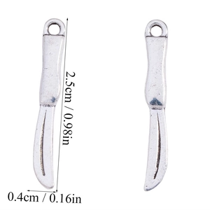 Macro detail showing 2.5cm silver scalpel charms with dimensions for jewelry making