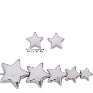 Macro shot of silver star-shaped CCB spacer beads with 0.8cm size measurements for DIY jewelry