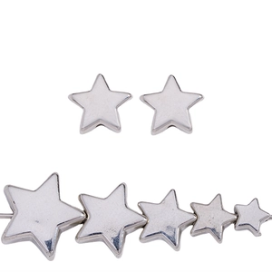 Detailed view of silver star beads in five different sizes for DIY jewelry projects