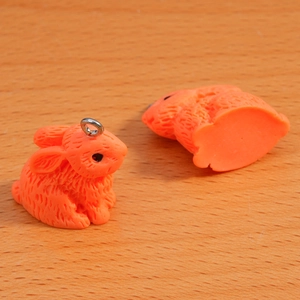 Macro shot of orange flocked rabbit pendant with detailed fur texture and metal ring
