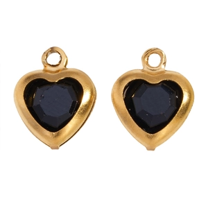 Detail of two heart-shaped black faceted glass charms with gold-plated frames for DIY jewelry