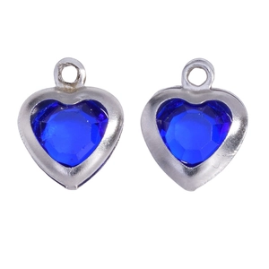 Close-up of deep blue heart-shaped crystal pendants with polished silver metal frames