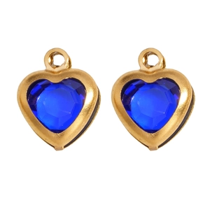 Macro detail of two heart-shaped blue glass pendants with golden stainless steel frames