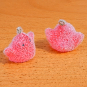 Macro shot of fluffy pink flocking chick pendants with metal loops for DIY crafts