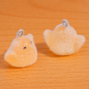 Detailed view of yellow flocked chick pendants with metal rings for DIY jewelry and keychains