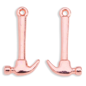 Macro view of two rose gold hammer charms for DIY jewelry making and necklace crafts