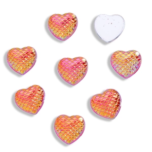 Macro view of 12mm heart shaped acrylic resin pieces with iridescent mermaid scale texture