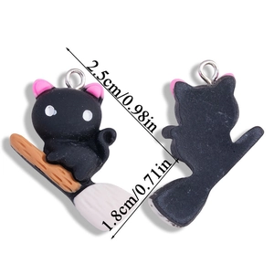 Front and back views of a black cat on a broomstick pendant with size measurements