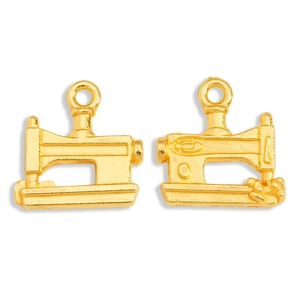 Macro shot of two golden vintage sewing machine charms for DIY jewelry making
