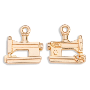 Macro detail of two golden alloy sewing machine charms for DIY jewelry making