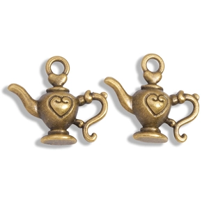 Close-up of vintage bronze alloy teapot charms with heart motifs for DIY jewelry making