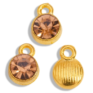 Macro shot of gold alloy pendants with champagne rhinestones for DIY jewelry making