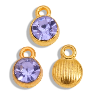 Macro detail of gold-plated round charms with light purple stones and ribbed texture