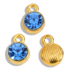 Detailed view of round gold alloy pendants with faceted dark blue crystal rhinestones