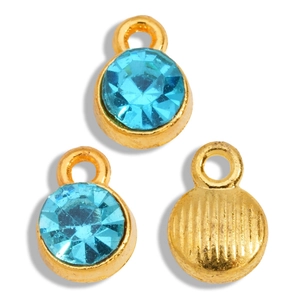 Macro detail of gold alloy pendants with light blue faceted crystals and striped backs