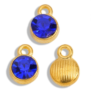 Detail of round dark blue crystal charms with textured gold alloy back and ring loop