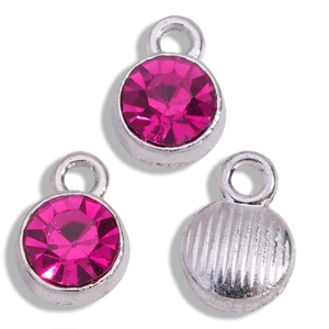 Detail of DIY jewelry pendants with rose red rhinestones and silver metal backing