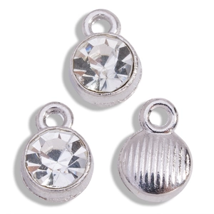 Detailed macro view of crystal rhinestones on silver alloy round birthstone pendants