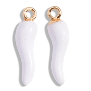 Macro shot of a pair of white enamel chili pendants with gold jumping rings on white base