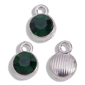 Detail of round dark green gemstone charms with silver metal bases for DIY jewelry