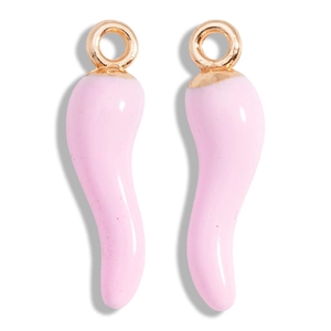 Macro shot of a pair of pink enamel chili pendants with golden metallic loops for DIY jewelry