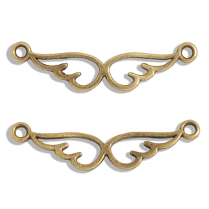 Detailed view of vintage bronze alloy wing connectors for DIY jewelry making