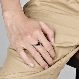 Stainless steel Yin Yang Tai Chi spinner ring for couples shown on a model's hand
