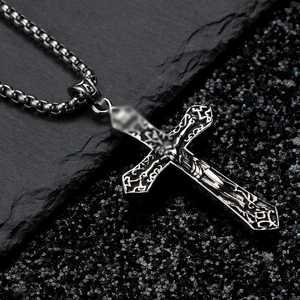 Vintage gothic titanium steel crucifix necklace with ornate relief on black rock background