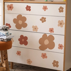 Bohemian style floral wall stickers in earthy tones applied to a white wooden cabinet
