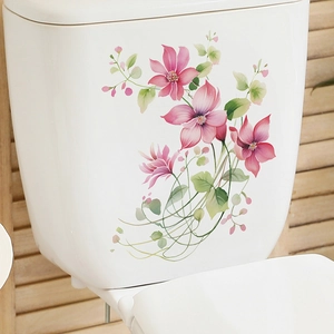 Detailed view of floral watercolor toilet stickers applied on white ceramic tank