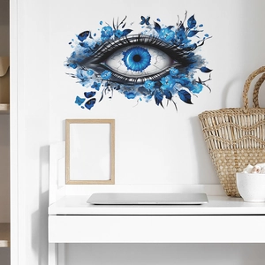 Artistic blue eye wall decal with floral and butterfly accents in a modern room setting
