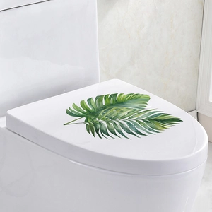 Waterproof self-adhesive tropical leaf wall sticker on a white bathroom toilet lid